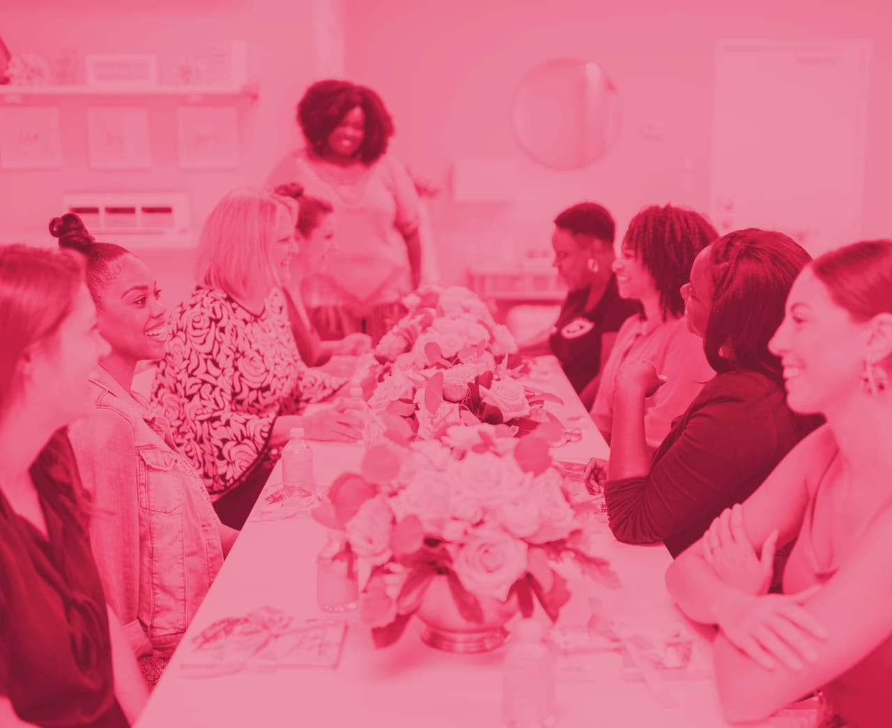 red tinted image of women at a table